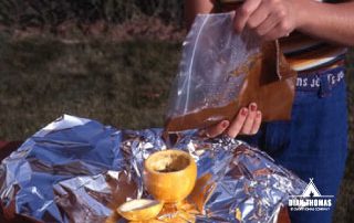 Pour chocolate cake in an orange to make a simple outdoor treat.
